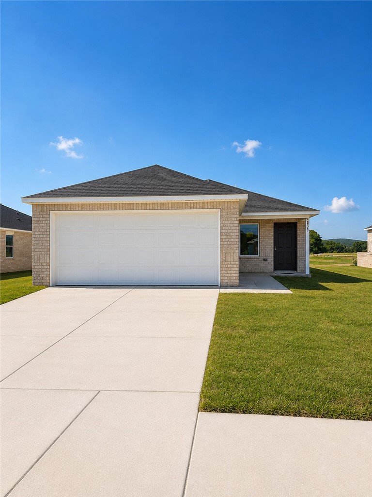 View of front of house featuring a garage, a shing