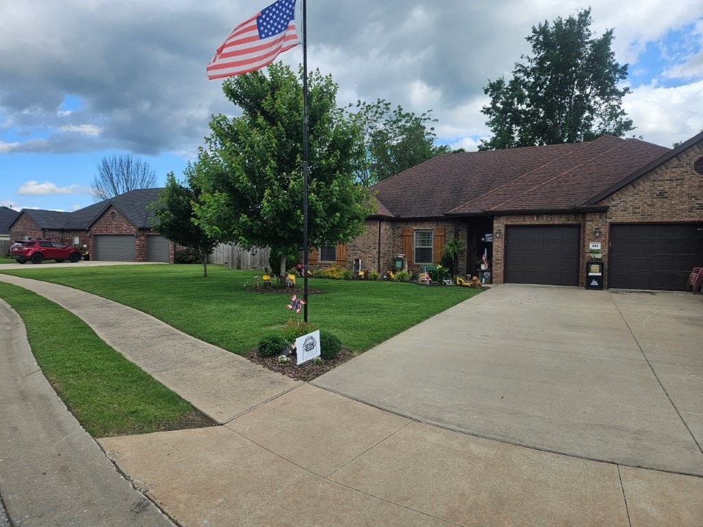 Located in the heart of Pea Ridge, AR, this nearly 2,000 sq. ft. home offers comfort, style, and functionality. With 3 spacious bedrooms and 2 full baths, the home features a desirable split floor plan that provides privacy and space. The primary suite includes a large walk-in closet, adding convenience and ample storage. The kitchen is both practical and inviting, boasting granite countertops, a gas range, built-in microwave, and an eat-in layout perfect for everyday living. Wood blinds add a touch of elegance, while the cathedral ceiling in the living room creates a bright, open feel. A cozy gas log fireplace anchors the space, making it ideal for relaxing evenings. Outside, enjoy a large, fully fenced backyard with a storage shed for tools or extra gear. The 3-car garage adds even more functionality w/ extended driveway, and sidewalks throughout the neighborhood are perfect for evening walks. This home is a perfect blend of charm and modern living in a peaceful community.