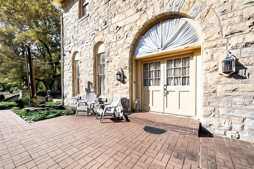 Historic lodging right across from the train station! This gorgeous limestone structure was built by the Ozarka Water Bottling Co in 1895 and is now the Brownstone Inn. Includes FIVE beautifully furnished, non-restricted short term rental suites, 6 parking spaces parking above and below, and a common dining/sitting area plus kitchen, all with independent central air. A detached limestone carriage house may be used as storage, a garage, or developed into more lodging or retail. A beautiful common-area deck overlooks the antique train cars. Plenty of utility and storage space. Financials available to qualified buyers. The rentals are professionally managed by a company willing to continue services for a seamless transition. State and Federal tax programs may offer up to a 45% tax credit on approved renovations.