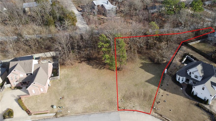 Build your dream home in this quiet neighborhood, while being right in the heart of Fayetteville! Watch the sunset over the tree-covered hills right from your front door! This building lot is located just off Mission Blvd in East Fayetteville at the base of Mt Sequoyah, near Root Elementary, shopping, parks, and trails. The new home must be a minimum of 2400 sf. Lot fronts 3 streets, possible entrance from rear.