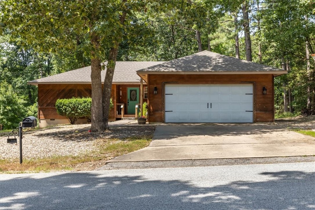 Welcome to 7 Mansfield Drive in Bella Vista! This 3-bed, 2-bath home features a split floor plan with a private primary suite, vaulted ceilings, and bay windows that fill the space with natural light. The living room boasts a wood-burning fireplace and flows into a spacious kitchen with ample cabinetry. Enjoy the large deck and generous backyardāperfect for relaxing or entertaining. Located near biking trails, golf courses, lakes, and parks, this home offers endless outdoor recreation. Great for a first-time homebuyer, weekend retreat, or second home!