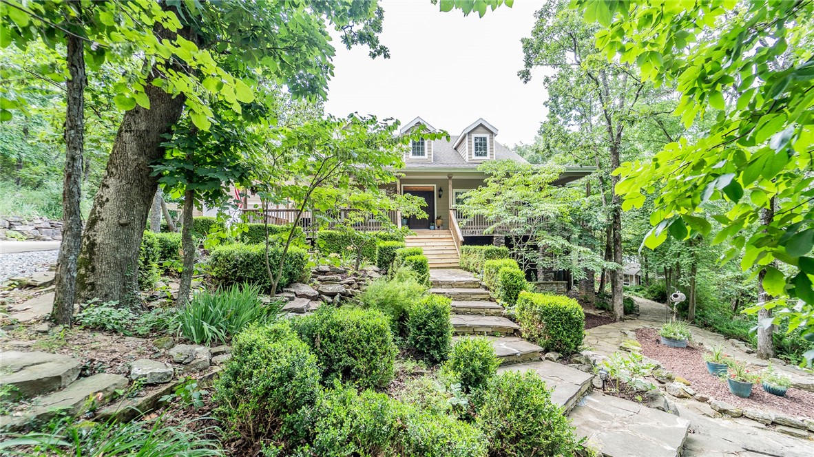 Executive home hidden in the woods just minutes from Fayetteville. This craftsman constructed home with landscaping to accentuate the natural beauty is the perfect place to raise a family with lots of additional space for game rooms, media rooms or office space. Basement could be used as a MIL quarters with the kitchenette or made into a lock-off. Extra large closets in every bedroom. The multiple outdoor living areas let you enjoy the serenity of being out of town or enjoy the sunroom all year long. A garden shed with water lets you work on your landscaped yard or use the rock, fenced patio for your hot tub retreat. Not included in the square footage is a separate apartment / tiny house (1000 sq ft). Make this your man cave, craft room, or guest quarters. Full kitchen and bath with privacy wall for sleeping makes this a great bonus space with separate utilities. Full home generator for winter safety. Plus 8.5 acres of woods to explore. Too much to list - must see to believe!
