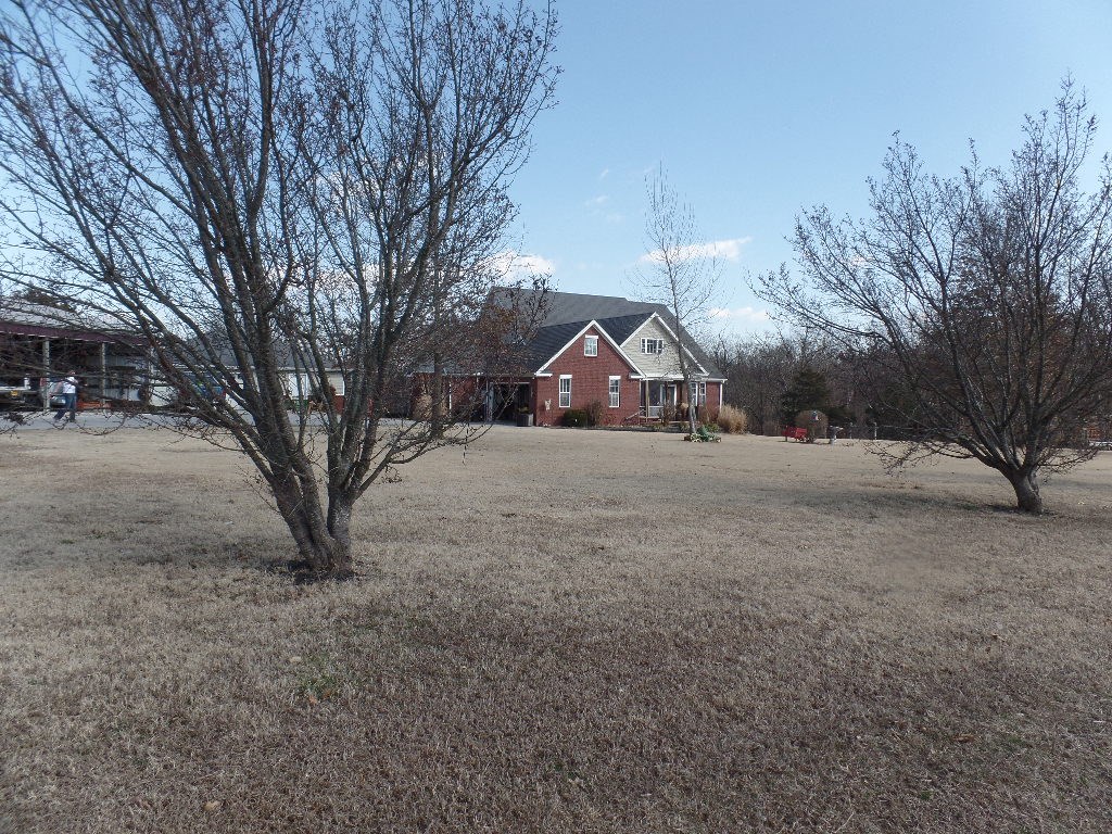 Perfect spot to raise a family! All brick home built in 1997. Located on 2.82 fenced acres for horses & cows, the property also includes a detached shop building that has electric, overhead door with approx. 1,000 sf, there is a 40 x 60 pole shed with six bays for equipment or trucks. The spacious LR has hardwood floors, it also features a wood burning fireplace with a wooded mantel. The eat in kitchen has stone-tiled floors and lots of cabinet and counter space.
