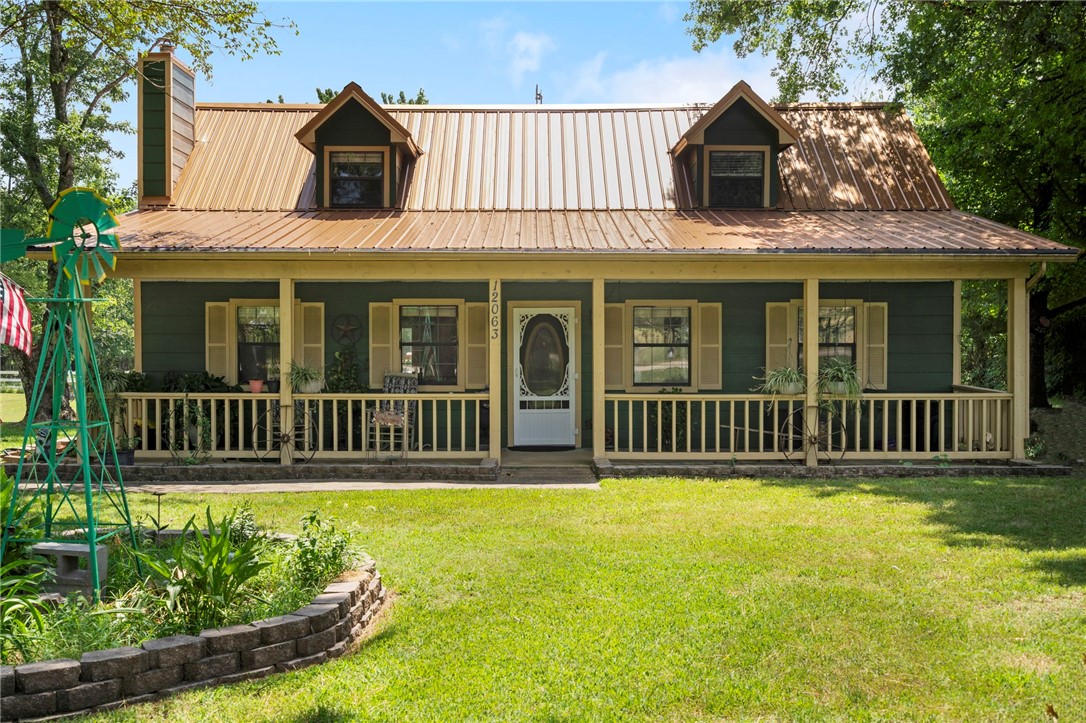 Your Country Oasis Awaits! Wake up to wide-open skies, the soft nicker of horses in the barn, and the peace of 2.05 +/- fully fenced & cross fenced acres - just 4 miles from the I-49 corridor, shopping, schools & medical care. This charming 3 bedroom, 2 bath home combines rustic warmth with everyday comfort. Spend slow mornings on the full-length front porch, or host summer gatherings in your backyard retreat, complete with an expertly built deck, 28' round pool and a shady gazebo. Inside, the inviting living room features a native stone fireplace ready for a wood stove (included). The kitchen boasts of a breakfast bar, large pantry, and generous counter space, while the spacious laundry room includes storage galore - even a built-in doggie door for your four- legged friends. The barn offers 4 stalls and a feed room, perfect for your equestrian dreams. A large shop building adds space for hobbies, storage, or a business. This isn't just a home - it's a place to breathe, grow, and truly live