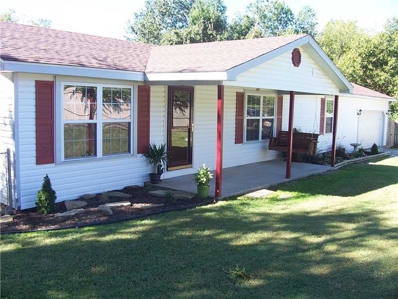 Adorable stick-built home with simple, clean lines to help keep utility bills low! Maintenance free exterior, 3bd/2ba, 1299sf with hardwood & tile flooring through out! Master suite has oversized tiled shower & double sinks with Corion counters! Galley,style kitchen boasts stylish tin backsplash & pantry area! Great extended outside living area on the deck overlooks a wooded ravine with a pond to catch the deer getting a drink! 8x8 Storm Cellar! Fenced for privacy, chain link fencing for the puppies!