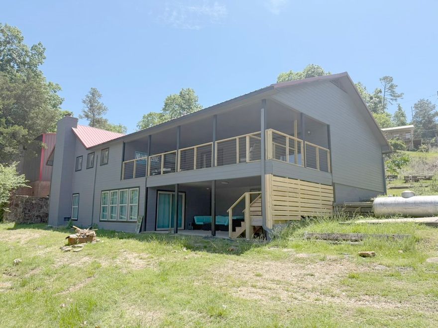 Lake Front!!! Turnkey House - Sold furnished with everything needed to rent as a short term rental or move right in. Amazing view overlooking Rocky Branch Marina. Large deck perfect for entertaining. Over 1/2 acre on the water. 1500 sf. detached shop. 109 ft of Shoreline, new water heater, new AC unit, remolded downstairs with new window and door.  This home can sleep 15 people in beds. King Bed-Master / twin over queen- room off of master for kids /  King Bed - Second Bedroom with its own full bath. Bunk room - 2 Queen bunk beds. Garage could be closed in to make additional SF.  The Lot could be split to build another home. Many opportunities with this home.