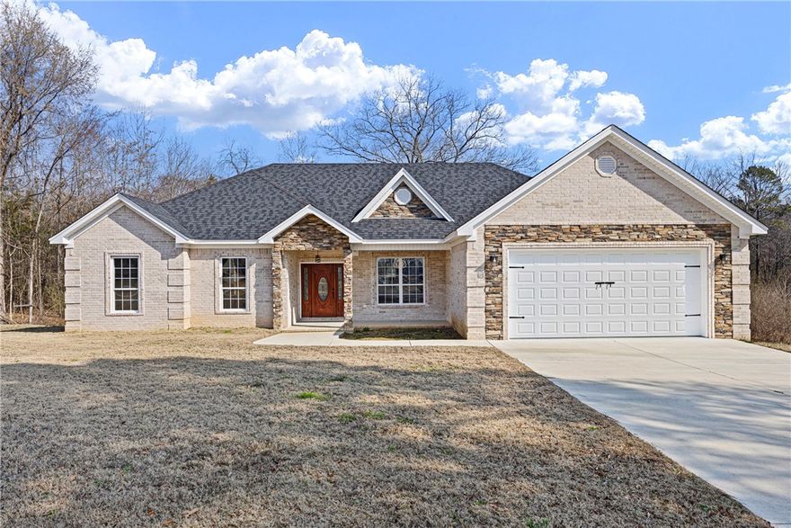 Welcome to this four-bedroom, two-bathroom home featuring an open-concept layout, granite countertops throughout, stainless steel appliances, and a spacious kitchen island. Two spacious tile bathrooms offer durability and style. The two-car garage features epoxy flake flooring and an aluminum ladder for attic access with built-in lighting and storage. Enjoy outdoor living on the covered concrete and stone back porch, offering a comfortable outdoor retreat perfect for Arkansas living. Don't miss your opportunity to make this thoughtfully designed home yours!