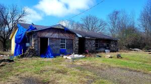 * 10 acres along Kneeland Creek* House had a fire being sold as is* Slab Foundation*City water and sewer on property* Part of land in flood plain, due to being located on a creek. House sits up on higher ground.