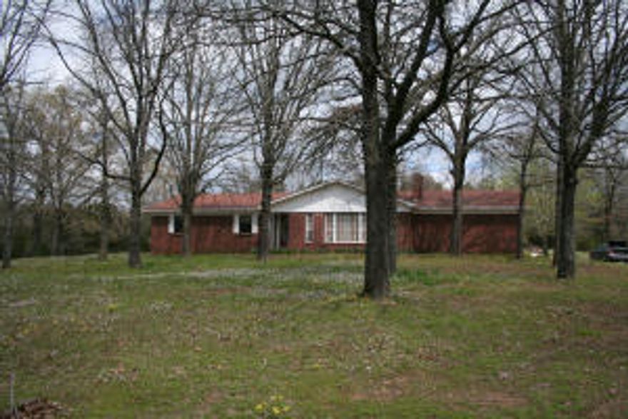 Brick home on 6.69 acres with great setting. Located at the end of the drive this property offers a pool, pool house, garage/ shop with shed on back, and pond. The home has 3 bedrooms, 2 bathrooms, and 2 living areas. The home and the pool are in need of some repairs
