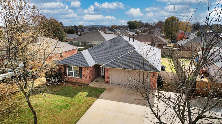 Welcome to this lovely move-in-ready, all-brick 3-bed, 2-bath home in quiet, established Springdale neighborhood. The 1,655 sq ft split-floorplan layout feels spacious & connected—arched entry leads to 10’ vaulted ceilings in living room. Accent wall & tray ceiling in primary suite add architectural charm. Kitchen & living areas flow easily. Enjoy fenced backyard with wooden privacy & partially covered concrete patio—ideal for pets, play, or peaceful evenings. Fully paid solar panels help lower electric bills—additional highlights: gas fireplace, newer appliances, 2-car garage, & extra parking out front. Nearby Dean's Trail with access to Razorback Greenway, Lake Springdale Trail & others. offer scenic rides for all skill levels. Convenient to Jones Center, Walmart Market, parks, schools, & major roads. Schedule your showing today.