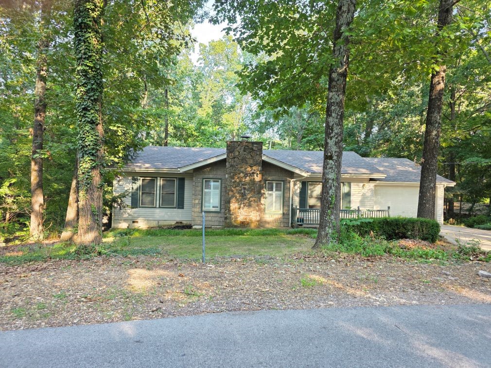 Location, Location, Location! Walk from your back yard or drive your golf cart to Riordan Hall Recreation Center Pool and Tennis Complex &enjoy a vacation lifestyle daily in this Fabulous 3 BR 2 Bath Split BR home on a beautiful wooded private lot with public sewer already installed! Wood floors in Living Room with Fireplace , plantation shutters, vaulted ceiling, Eat in breakfast nook with built ins. This light and bright area would make a great remote home office with built in desk area./shelves huge sundeck that leads downstairs to a walk out basement. Home has walk in closets, solar tube lighting glass walk in shower. A combo tub in in primary bath. Opportunity awaits you! Amazing basement area w/additional outdoor storage Beautiful gardens started by the original owner offers a park like setting designed for nature lovers! Minutes to Bentonville. Easy access to 71 Business/ Shopping, movies, lakes, waterfalls, biking and hiking trails. The best of both worlds! This is paradise within NW AR & the Ozarks!