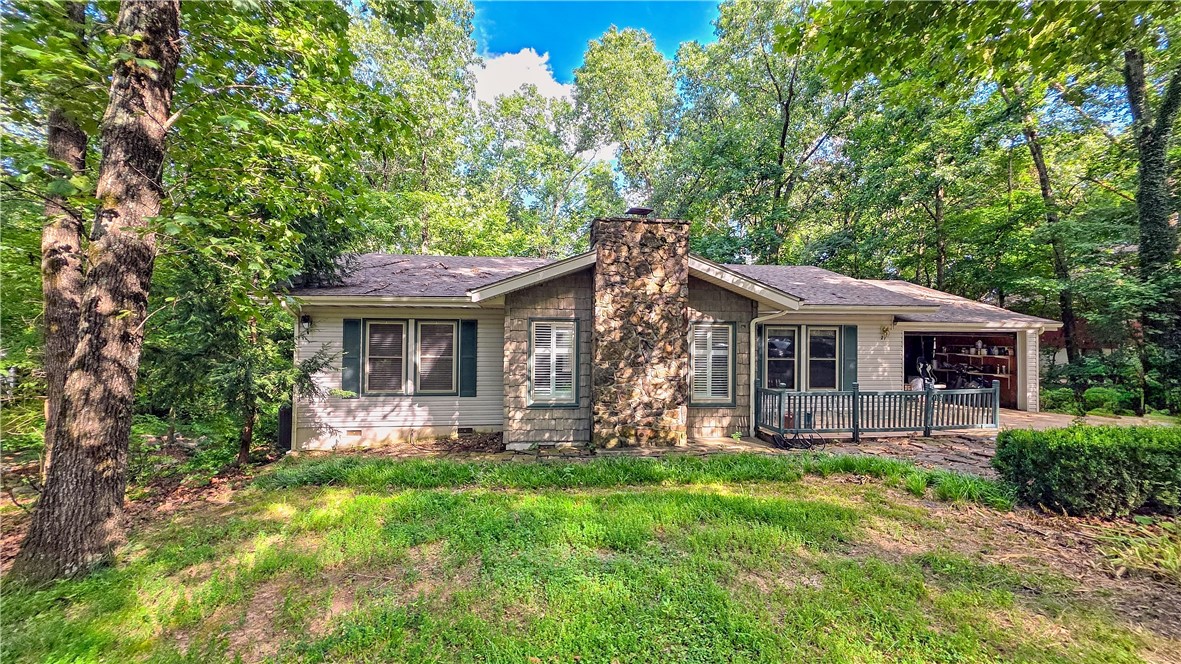 Location, Location, Location! Walk from your back yard or drive your golf cart to Riordan Hall Recreation Center Pool and Tennis Complex &enjoy a vacation lifestyle daily in this Fabulous 3 BR 2 Bath Split BR home on a beautiful wooded private lot with public sewer already installed! Wood floors in Living Room with Fireplace , plantation shutters, vaulted ceiling, Eat in breakfast nook with built ins. This light and bright area would make a great remote home office with built in desk area./shelves huge sundeck that leads downstairs to a walk out basement. Home has walk in closets, solar tube lighting glass walk in shower. A combo tub in in primary bath. Opportunity awaits you! Amazing basement area w/additional outdoor storage Beautiful gardens started by the original owner offers a park like setting designed for nature lovers! Minutes to Bentonville. Easy access to 71 Business/ Shopping, movies, lakes, waterfalls, biking and hiking trails. The best of both worlds! This is paradise within NW AR & the Ozarks!