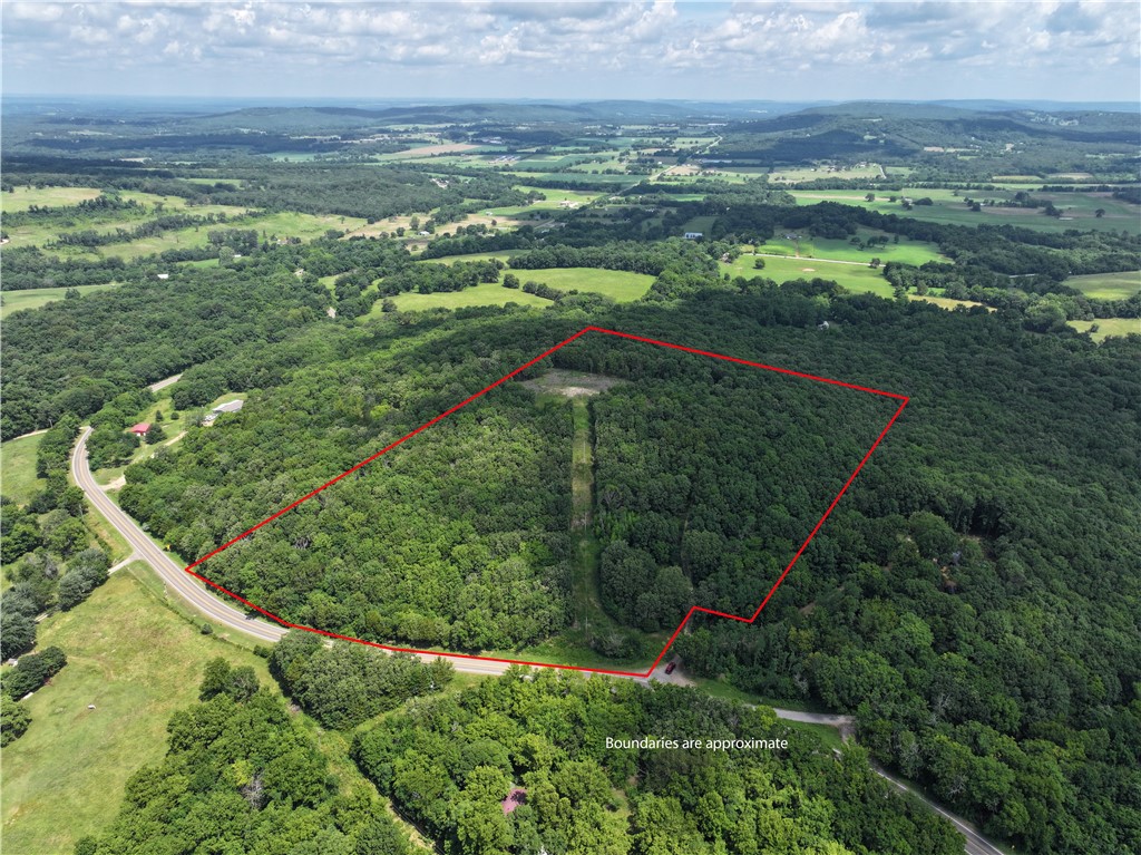 Premier 20-Acre Hilltop Site with Build-Ready Flat Pad. Discover the ideal setting for your dream home on this expansive 20-acre parcel, featuring a spacious, level build site atop the hill with immediate construction access. Nestled among mature trees, the property offers outstanding privacy and sweeping, panoramic views—perfect for creating a serene retreat. Conveniently located just off Highway 59 and zoned within the desirable Lincoln School District, with electric on site and public water at the road. Don’t miss out on this rare opportunity to secure a private, picturesque homesite in Northwest Arkansas.