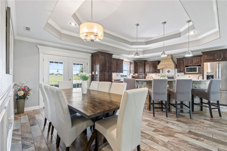 Escape to tranquility with this stunning Custom Craftsman style home nestled on 14.23 picturesque acres in the heart of the countryside. Interior includes 2103 sq ft, 3 bedroom, 2 1/2 bath, office and open floor plan with ample space for family living. A dream kitchen with double tray ceiling, timeless custom two tone cabinets, large pantry, stone island, granite countertops, and stainless steel appliances. Living room is perfect for those cozy nights with a warm pellet stove, stone fireplace wall with built ins and vaulted ceilings with handcrafted cedar beams. Primary suite and bath have private entrance from patio, elegant walk in shower, and vanity. Outside this home boasts timeless architectural beauty with detailed cedar, stone accents, and large front and rear porches for relaxation and entertaining. Jumbo storm shelter, 40x60 insulated shop with 12x60 lean-to, and an RV awning. Too many amenities to list! Enjoy the privacy and quiet of rural living while still being conveniently located close to town.