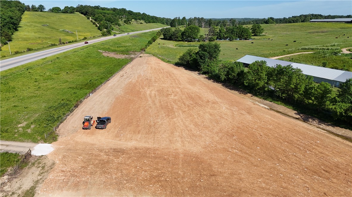 Prime 1.5 acres with over 500ft of Hwy 412 frontage. Zoned dual use (DUZ) with city water/sewer, natural gas, electric, and fiber optic available on site. Desirable commercial location with high visibility and traffic in a growing area. Cleared, level with dirt work done. Across from Huntsville Walmart Supercenter and other thriving businesses. Adjoining 2.2 acres also available.
