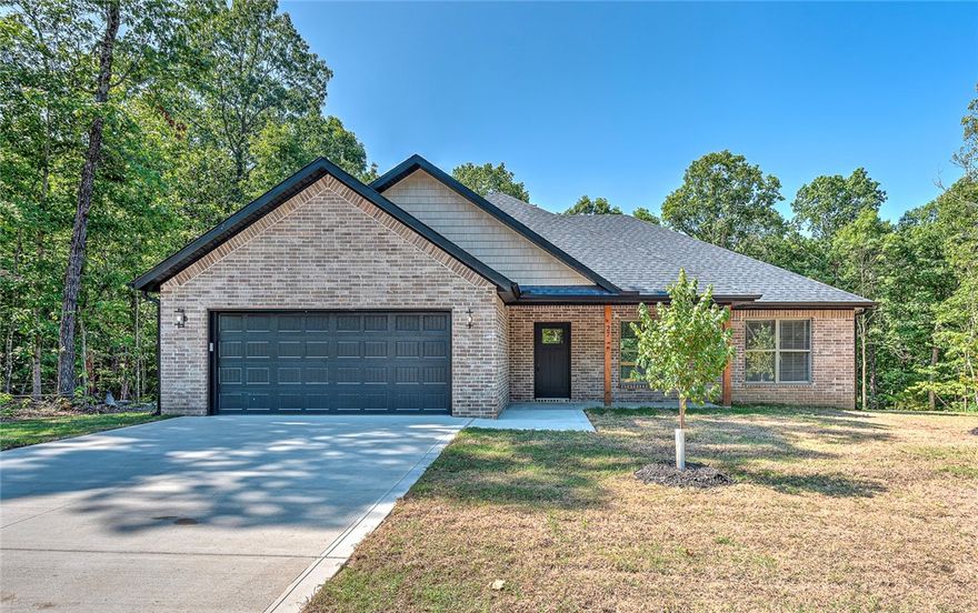Seller offering $3,000 toward buyer’s closing costs! Pristine new construction in peaceful Bella Vista. This open-concept, split floor plan home showcases exceptional attention to detail. Natural light fills the interior, and both the front and back covered porches invite you to relax and enjoy the beautiful surroundings. Features include under-cabinet kitchen lighting & tile backsplash, upgraded 3cm granite countertops throughout, a spacious kitchen pantry, a mudroom hutch, and built-in shelving in the laundry room. The home is truly move-in ready, complete with blinds, gutters, and a luxurious tiled primary shower with a modern glass door. Even the oversized garage is finished with trim, blinds, and a super-quiet garage door opener with a built-in camera. One-year Builder Warranty included! Don’t miss your chance to own a quality home in one of Northwest Arkansas’s most desirable communities - schedule your showing today!