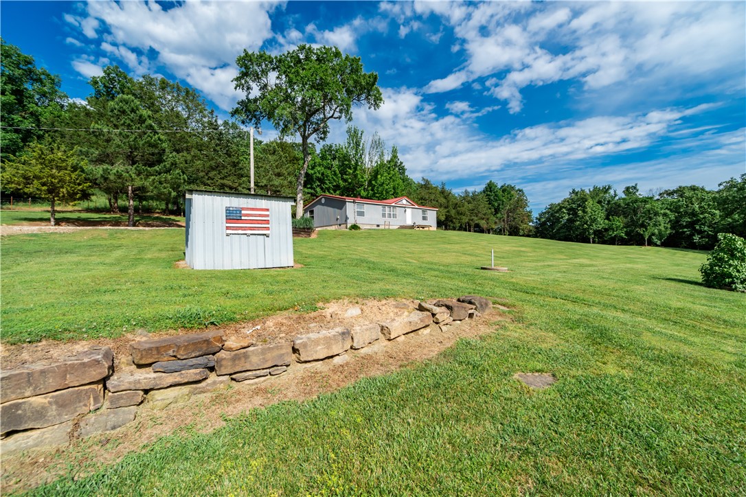 Well-kept manufactured home on 4 scenic acres just outside of Elkins. Enjoy excellent valley views from this 3 bedroom, 2 bathroom, 1,296 sqft home with a durable metal roof. The interior has a contemporary touch, providing a stylish and comfortable living space. The property features rural water hookup and a there is a dug rock well and a drilled well. Thereās plenty of space for projects with a large two-bay garage/shop and a tall carport. 30x40 shop is full insulated with 10ā overhangs on each side, shop has electric and water as well. The RV garage is 20x48. Ideal for those seeking a peaceful rural setting with convenient amenities. Schedule a tour today!