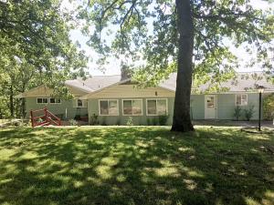 Year round view of Bull Shoals Lake. This is a well-kept, spacious home with a separate workshop building, and 3 extra lots for privacy. Storm shelter entrance from side. Large den could be changed to smaller den and 3rd bedroom by adding a wall in the middle.