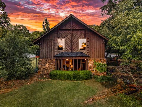 This is a rare opportunity to own a one-of-a-kind luxury home in Fayetteville’s Historic/Mt. Sequoyah district! This former church, masterfully redesigned by Mark Zweig, blends contemporary elegance with barn-dominium charm. A high-performing short-term rental, it features two independent living quarters, a stunning Great Room with a Chef’s Kitchen, multiple entertainment spaces, and breathtaking sunset views. The lower-level studio suite offers a full kitchen, private entrance, and flexible layout. Additional highlights include a dedicated office nook, flexible sleeping quarters, dining and living areas, a full bath, laundry with walk-in closet, and ample storage. Situated on an oversized corner lot with space for a garage, ADU, and ample parking, this turnkey investment or dream home is a must-see! Schedule your showing today!
Short term rental license to transfer to buyer with city approval.