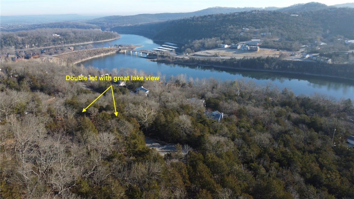 Great price for over a half acre with lovely lake views! This double lot is located on lovely Holiday Island and is R1. Minutes from the two pro golf courses, community pool, and historic Eureka Springs! Located <4 minutes from Table Rock/Holiday Island Marina- dock your boat for the summer and enjoy your new dream home or investment property in the glorious Ozarks!