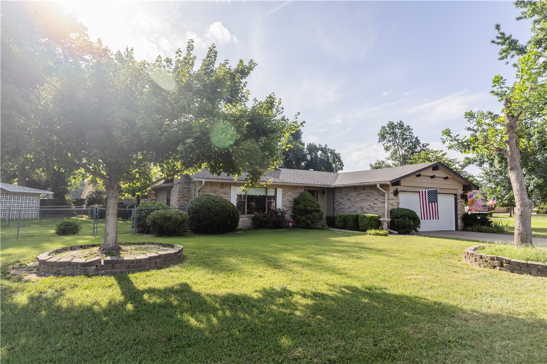 Welcome to the neighborhood! Well-established, mature area with easy access to the Greenway as well as all major areas in Rogers. This extremely well taken care of home offers 3 bedrooms and 2 baths! Ceramic tile in bathrooms, kitchen. No carpet. Newer master tiled shower, new hot water heater, and new roof with new gutters that prevent debris from entering. Extra insulation to ensure comfort and utility savings. AC/heat is a dual heat pump system with programable thermostat. Irrigation system has a separate meter to help keep your yard looking green all summer long. Wood-burning fireplace with gas logs. Home comes with a 1-year home warranty. There is a small portion of the wrought iron fence by the patio that will not convey. The home has some custom built-ins that offer extra storage and are also very appealing. If you are looking for a fantastic neighborhood in the heart of Rogers, this is a must-see!