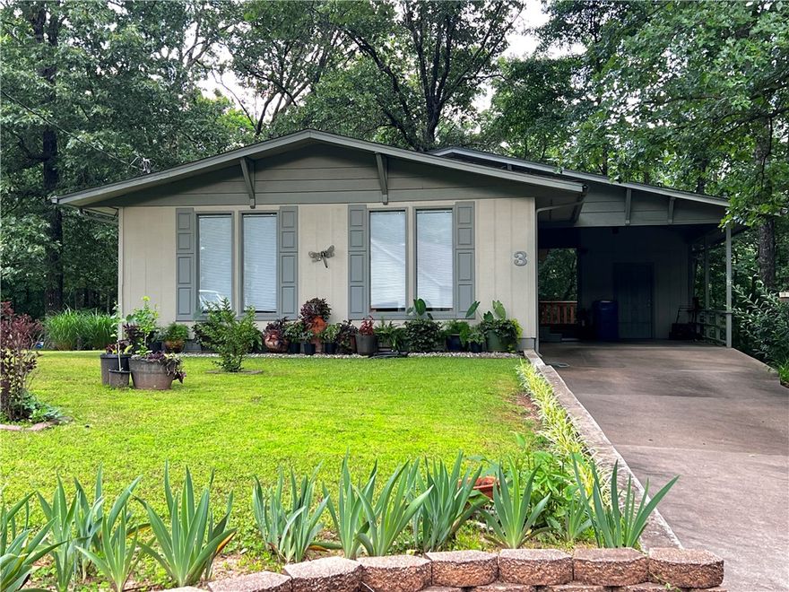 This is an awesome opportunity to own a  classic Bella Vista home with truly easy access to our world-class mountain bike trails! Watch riders drop-in on Flo-Ride from your back deck. Create your own short path directly to the trail (with POA approval) or ride the path from the house 350ft. to the trail crossing on E. Lancashire.  This charming home has been lovingly maintained with lots of updates over the years including a new roof in Oct. 2019, new heat pump in Oct. 2020, new windows and interior doors in 2018, new oven/range in 2025 and more. Tucked in a cozy cul-de-sac surrounded by nature this home is a gem!