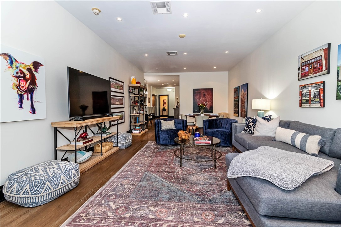 Stunning, spacious condo located in the heart of downtown Fayetteville in the luxurious Legacy building! Elegant living with open concept, quartz countertops, wood look tile flooring, natural light, and covered balcony! Kitchen is equipped with stainless steel appliances, ice maker, tile backsplash, tons of cabinetry, and breakfast bar. Plenty of room to entertain! Secured-entry building offers large lobby, gym, and recreation room with TV and kitchenette. One deeded parking space in private/secure garage to convey with condo. Just steps away from Dickson, Walton Arts Center, and U of A - the ultimate location!