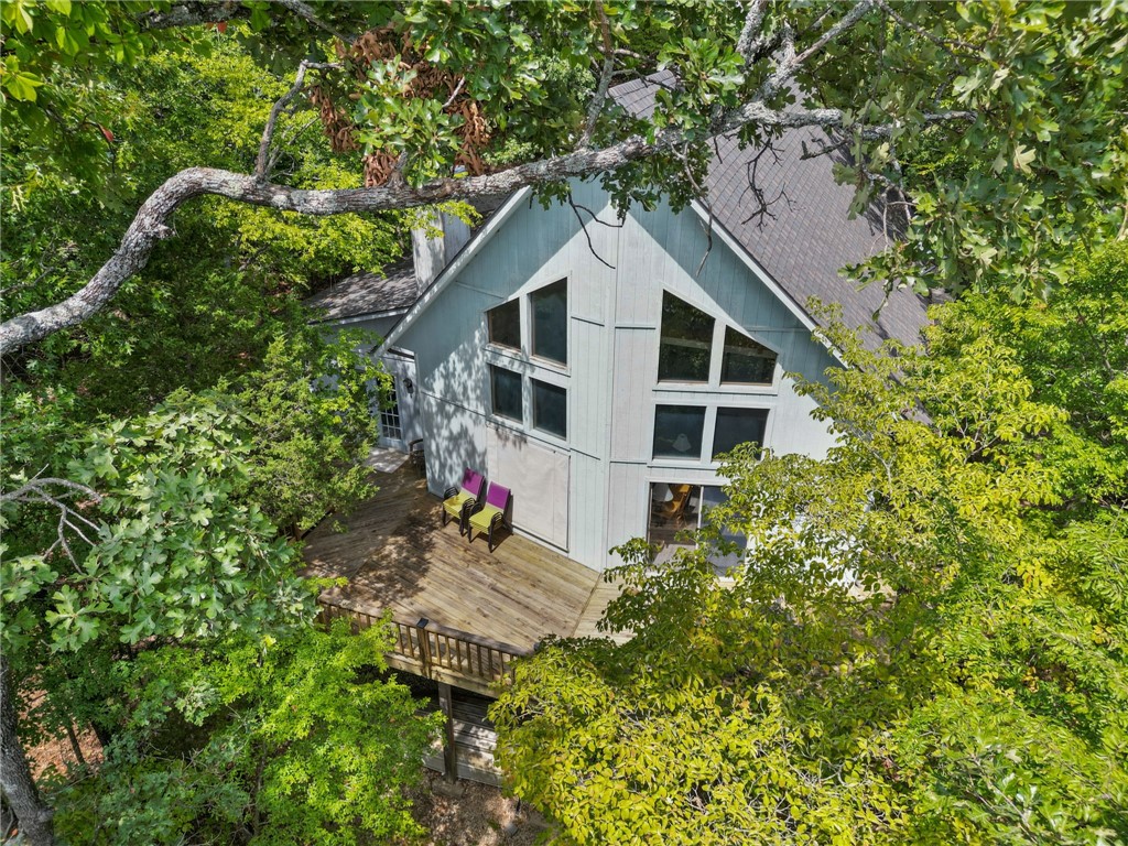Charming Lakefront Retreat on Beaver Lake in this 3-bedroom, 3-bathroom home with a spacious loft that offers an unparalleled opportunity for lakefront living. Located on a serene, private stretch of Beaver Lake, this property boasts an impressive 739 feet of prime lake frontage. The 6.42 acres give opportunity for possible development or complete privacy. Step inside to discover a bright and airy open floor plan, featuring a cozy living area with vaulted ceilings, a stone fireplace, and large windows that bring the beauty of the outdoors in. The main level includes 3 bedrooms and 2 baths while the upstairs loft also includes a large closet and full bathroom. A highlight of this property is its two-slip private dock, offering easy access for your boat, kayaks, or any water activities you desire. The loft provides additional flexible space, perfect for a home office, game room, or extra guest area. Don’t miss out on this rare opportunity to own a slice of paradise on Beaver Lake!