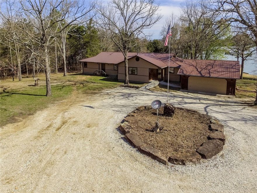 Wow! This beautiful lake front property is perfect. It boasts great views of the lake from multiple rooms! Easy walk to the dock. Gated private drive, open floor plan and private dock. Huge shop/barn- 1800sf slab, double sided shop 60ftx30ft, 11' 9" wide and 12' tall sliding door, 300sqft overhead loft storage, two full sets of cabinets. Lake Pavilion- 600sf on concrete slab with full electric, lights, fans. 600 sf storage building 30' long by 20' wide. Fishing Shed. Garden. What a property! Welcome home!