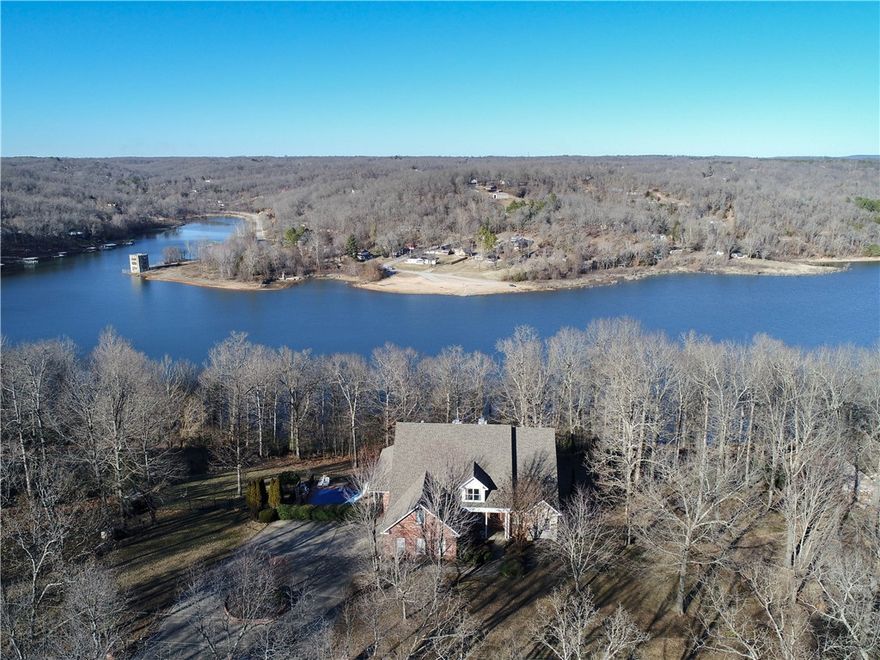 Lake front living! Huge executive home nestled on 2.5 private acres in a Gated Neighborhood on Beaver Lake. Fantastic Lake Views, private in-ground heated pool. New wood floors on main & second floor (12/2019). Large kitchen with granite counters and two islands. Updated paint and light fixtures. Theater room, billiards room, second full kitchen in lower level (could be mother-in-laws suite) Attached workshop with overhead door! Community dock; Boat Slip and Lift to convey with accepted offer! Located on a well known Beaver Lake Cove! Move in ready - enjoy the spring and summer here! This home is perfect for your family and/or entertaining! Recent upgrades include: backup generator, new wood floors on 2 levels, pool heater, new heat and air units, master bath remodel, fresh paint and light fixtures. Many extras in this stunning home include tons of storage, amazing lake views, plenty of natural light, indoor and outdoor entertaining space. Live the dream! This home has it all - make it yours!