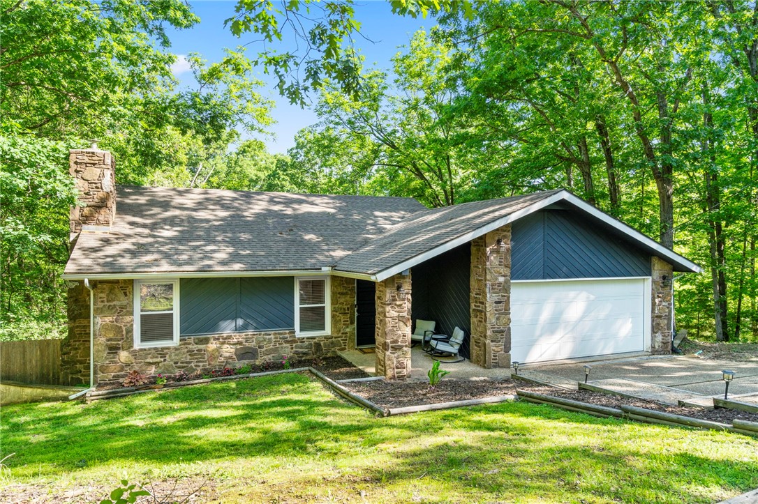 Nestled in the trees and tucked away on a private street, this home is in one of Bella Vista’s most coveted locations. Just minutes from the Lake Windsor boat launch, Riordan Hall community center, scenic mountain biking trails, and the exciting new OZ Trails Bike Park, the incredible location is a dream for outdoor enthusiasts and nature lovers alike. The main level offers a cozy space featuring 2 bedrooms, 2 full bathrooms, an eat-in kitchen, access to the large back deck, and a charming stone wood-burning fireplace in the living room. Downstairs, the walkout basement includes a third bedroom, full bath, a second living area, an abundance of storage, and an oversized workshop space—perfect for hobbies, guests, or multi-generational living. Enjoy tranquil mornings or relaxing evenings on the peaceful back deck, overlooking the large fenced backyard surrounded by trees. Discover the beauty of Bella Vista and all of the amazing amenities offered in this wonderful home!