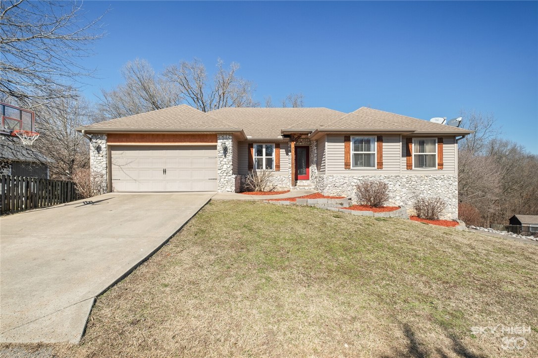 Charming two level home in Southeast Bella Vista. This home features 3 bedrooms and 2 bathrooms upstairs and a large living area, & a covered deck to enjoy your spring mornings. Large open feel with cathedral and tray ceilings in multiple rooms. The lower level has one bedroom and full bath with stained concrete flooring for your exercise room, media room, or kids playroom. Media room downstairs has equipment, speakers, and projector which are negotiable. Backyard has wood privacy fence. Located near the Back 40 trail system and Metfield Clubhouse. Easy commute to Bentonville or Rogers via Pea Ridge. Plenty of storage underneath home for additional workshop area. Bentonville Schools.