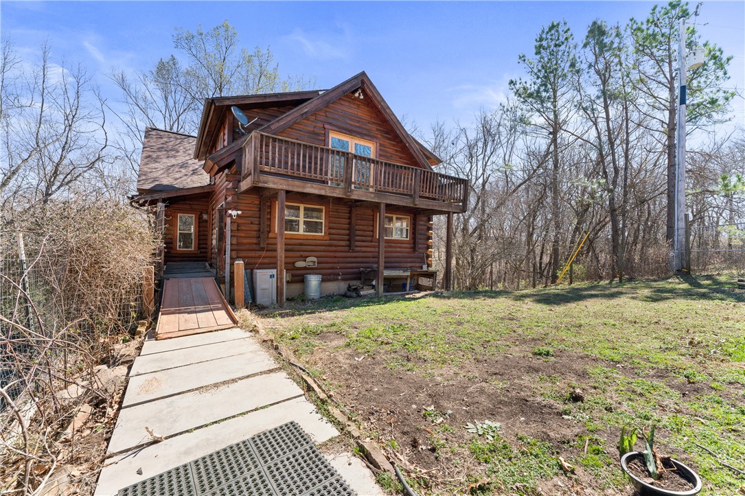 Embrace rustic charm and modern convenience with this stunning 3-bed, 2-bath log home on 6.54 acres in Prairie Grove! Whether you're looking for a private retreat, family home, or investment opportunity, this property offers endless potential. Step inside to be greeted by warm wood interiors and an inviting open-concept design, perfect for relaxing or entertaining. The spacious kitchen provides ample storage, while the large living area is ideal for cozy evenings by the fireplace. Outside, the expansive acreage is dotted with majestic walnut trees and other impressive hardwoods, creating a serene and picturesque setting. There's plenty of room to roam, plant a garden, add outbuildings, or even start a small farm. Enjoy the peace of country living while still being just minutes from local amenities. With room to grow and a fantastic location, this log home is a rare find. Whether you're looking to settle down, invest, or create your dream homestead, this property is a must-see!