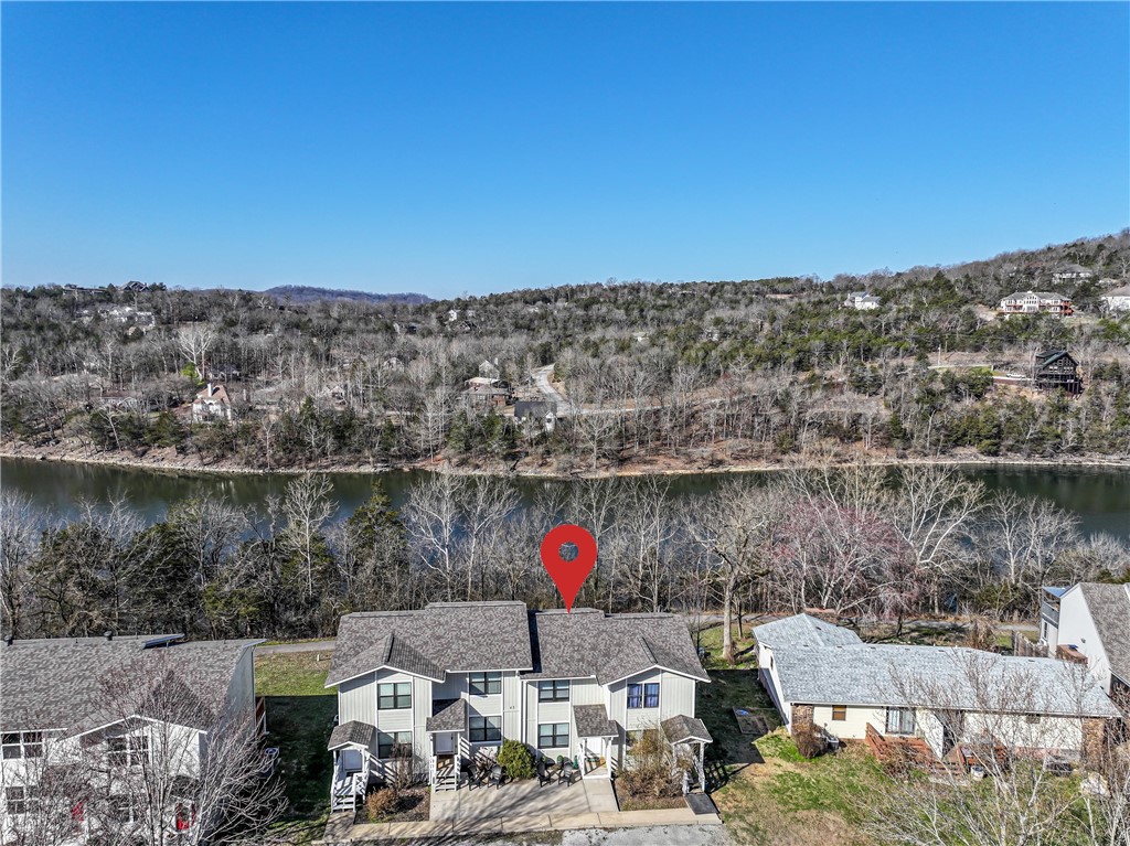 This waterfront condo is beautifully updated and fully furnished. Lovely lakeside walking trail runs directly behind the home. Close to Holiday Island Marina and Recreation Center with pools, pickleball, tennis, golf and more. Light and bright open layout downstairs with decks on the upper and lower levels overlooking the water. Matching kitchen island rolls and can be moved. Brand new roof added in 2024. The $154 monthly condo fee covers Holiday Island assessment, lawncare, trash pickup, and insurance covering the building interior and exterior. Washer and dryer convey. A wonderful getaway home, nightly rental, starter home or retirement townhome.