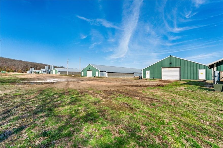 Please DO NOT ENTER without an appointment/ appropriate representation.  BioSecure Farm in operation.
Poultry Farm on approx. 35 acres m/l- to be determined by new survey, partially cleared. Six (6) broiler houses including four (4)-40x400 and two (2)- 43x500. Room for expansion and additional agricultural use. Buyer to negotiate contract and/or upgrades/improvements. Additional buildings-generator shed, stacking shed, one additional storage shed.  well water with rural water backup and storage tanks--natural gas for heat.  Well maintained.