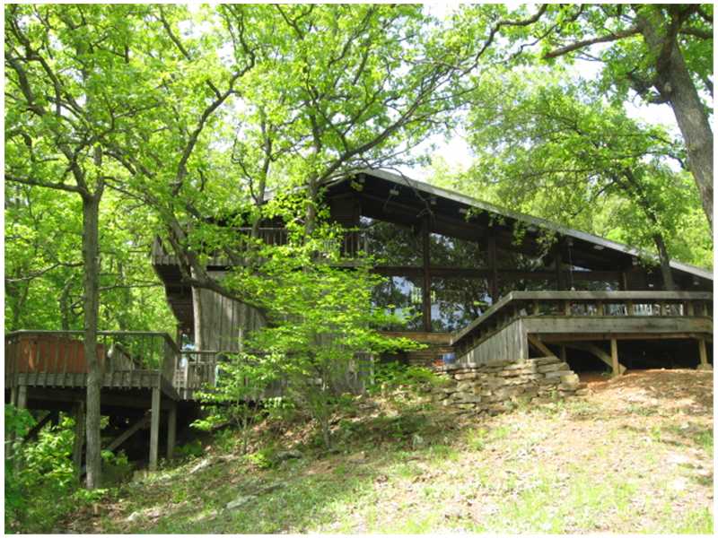 Peaceful tranquility at Frank Lloyd Wright-inspired beauty nestled among 12.28 private acres just 5 minutes from shopping & restaurants! One-of-a-kind contemporary, 2 bed, 3 bath w/formal dining, study, bar/serving/storage room. Open kitchen to soaring,living room & scads of windows overlooking 3000 SF deck. Private decks, outdoor shower on deck, in-wall storage throughout, cross-ventilation panels. Full walk-out basement has laundry/mechanical, could easily become rec room. Creek-fed pond.