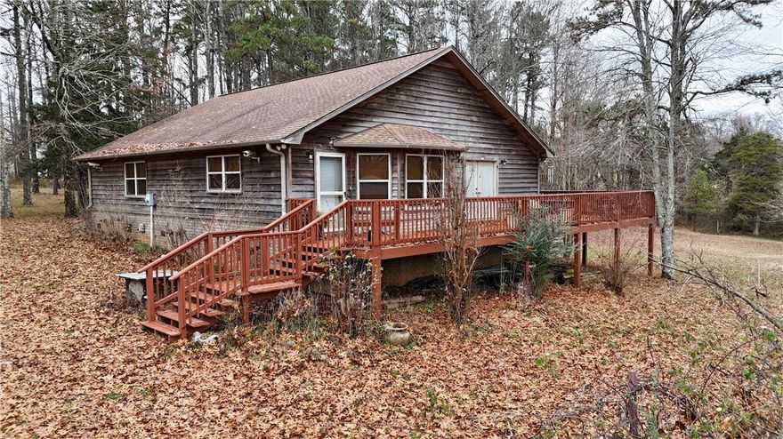 Imagine living just off Scenic highway 21 in Ozone, close to thousands of acres of National Forest, hiking trails, waterfalls, creeks, and lakes. It can be your reality with this gem. The home is nestled on a private 12.54 acres m/l that is fenced in with a cedar sided home,  40 x 40 metal utility building with electric, a pond, duck house, smaller outbuilding and a wet weather creek. The perimeter is surrounded with mature trees with some cleared interior that's usable for all your needs. The home is an open concept with 3 bedrooms. Beneath the wrap around deck you'll appreciate the large crawl space with a well and filtration system. The seller will negotiate leaving a newer zero turn mower, gas cans, gardening tools, wagons, rakes, and furniture in the home. If you desire fresh mountain air and living in a rural nature rich environment, this is a home to see!