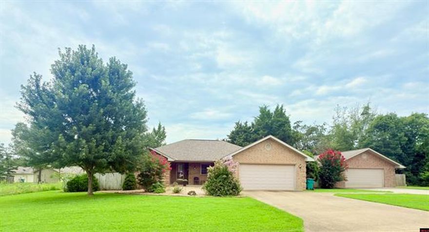 One mile to Lake access! This stunning all-brick three-bedroom residence, plus an office, offers a perfect blend of comfort and style. Step inside to find a spacious living room featuring a tray ceiling, leading to a well-appointed kitchen with a pantry and breakfast nook. The inviting dining area flows into a heated/cooled sunroom, ideal for relaxation. The primary bedroom boasts a walk-in closet and a well-designed bath with a shower and deep soaking tub. Enjoy the convenience of a two-car garage plus an additional two-car garage with a heated/cooled workshop area and ample room for a boat and cars