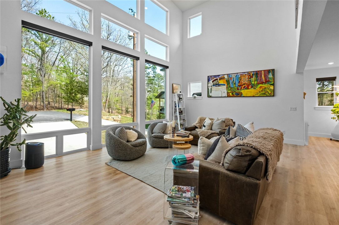 Where gorgeous modern comfort meets natural beauty. Professionally crafted in 2022 on over a half an acre sewered lot. This home features 3BR/3.5BA + office. Main level includes: floor to ceiling windows bringing in the natural light, eat in kitchen, Frigidaire Gallery appliances & quartz countertops. The main level has a bedroom, full bath, utility, double sided FP in living room/back balcony. Sliding french doors off DR open to covered deck with composite decking that help you take in the tranquil setting of this home & extend the entertaining. Upstairs features: main bedroom with walk-in closet & en-suite bathroom featuring walk-in shower, water closet, and double vanity. Second guest bedroom is also upstairs with full bathroom access from hall. Basement features garage, storage lockers, built in desk & plenty of storage along with added office. Metal Cowboy pool conveys, near Back 40 Biking Trails, & wood/chain link fenced in yard. Come see the high end custom finishes mixed with beautiful designer touches.