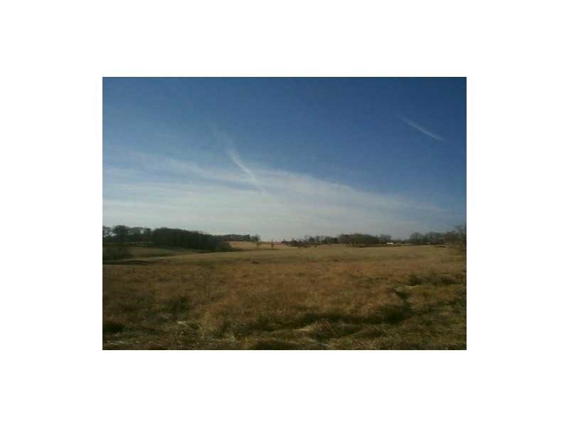 Unheard of in Northwest Arkansas! Prime commercial land priced below $1.70 per square foot!! A smart investment, whether you buy and develop now or buy and hold for future return. 37-acres, more or less, of commercially-zoned land at the very entrance to XNA (NWA National Airport). Major road frontage with access on both Arkansas Highway 264 and Hendrix Road, but in the future, it will have frontage on a THIRD roadway. When the Airport Access Road coming from I-49/I-612 from the south is completed, every vehicle traveling that roadway will pass directly past this property making it one of the most visible properties in all of Northwest Arkansas. Ideal for Corporate Headquarters, or Retail Development. Sewer service 1 mile away; all other utilities on site. Located in the City of Highfill, but with a Bentonville mailing address. Former location of the iconic Hendrix Boot Store, since razed. Rent house on property "as is." Also listed as Land MLS #1185266.