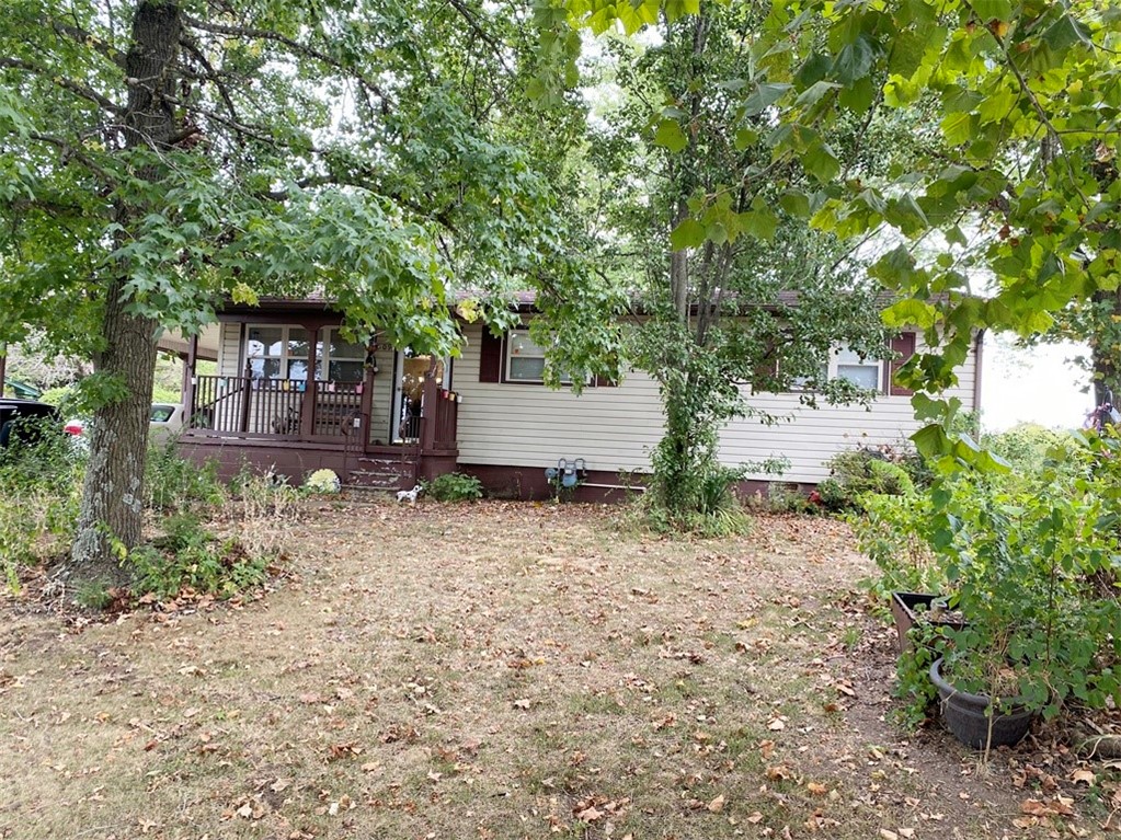 Vinyl sided 3 bedroom 1 bath home with carpet, vinyl, and hardwood floors. CH/A, range, refrigerator, gas fireplace, vinyl windows, covered patio in back, new roof 3 years ago, heat/air 10 years old, and lots of outside storage!