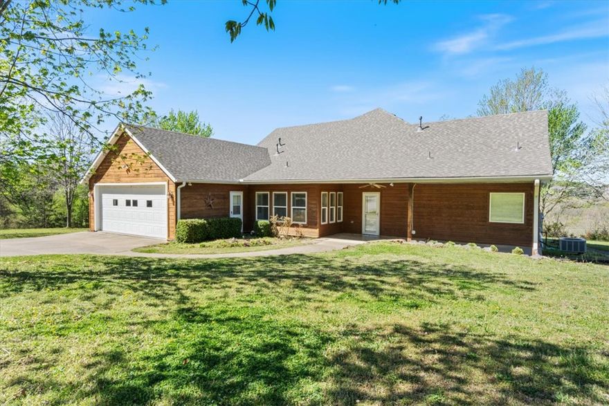 Spacious home and large shop sitting on 9 acres just off Hwy 412. A great mix of open, usable acreage with all the conveniences of town. Large, fenced pasture with a pond and great views. Well kept home with new roof and an extremely spacious kitchen and living area. Master has large walk in closet along with bonus room attached, providing plenty of storage and the perfect spot for an office. Beautiful west facing back deck perfect for watching sunsets. Tons of space in the shop with roughly 1300 sq ft of open, covered area for vehicles and equipment. Another 1300 sq ft of enclosed space with 6 total overhead doors for security and easy access. Plenty of room to expand or develop in this great location.