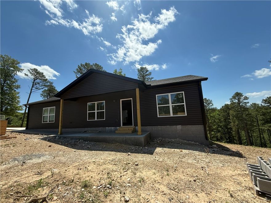 Want the best of both worlds? Away from the hustle & bustle, but also still close enough that it only takes a few minutes to town. You want new construction, but you don't want to be in a subdivision. Then this house is for you. Charming new construction that is only a few minutes from Beaver Lake in Prairie Creek & 15 minutes to Downtown Rogers. 3 bedroom, 2 bath, with a 2 car garage. Enjoy the peace & quiet on your covered front porch or back patio. There is also a spot cleared that the new owner could put a 30x30 shop on. This home is a must see!!!