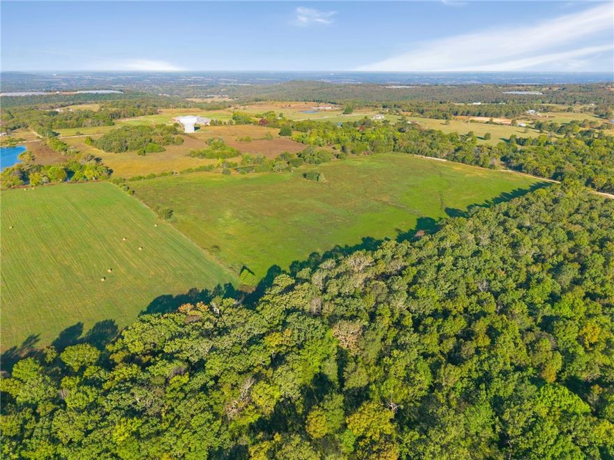 13.07 Beautiful Acres Located on Jackson Hwy! - Perched on a scenic ridgetop north of Lincoln Lake, this 13.07 Acres offers breathtaking views, established pasture and hay ground, and a fully stocked pond; making it ideal for livestock, recreation, or a peaceful homestead. This property contains a beautiful grove of century-old oak trees and mature hardwoods. The land is fully fenced and features city water and all other utilities available at the road. Enjoy privacy and convenience, just 10 minutes to Lincoln schools, shopping, gas, and dining, 20 minutes to Siloam Springs or historic Prairie Grove, and only 30 minutes to the University of Arkansas. 
Whether you're seeking a beautiful place to build your home, working farm, private getaway, or a piece of local history to make your own — this remarkable property offers it all. More land is available to purchase if desired. Also See MLS# 1326221, 1326228, 1326237, 1326244, 1326252