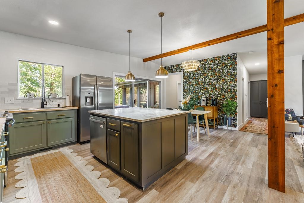 Charming, Updated & Move-In Ready! Step into this beautifully remodeled gem featuring luxurious Quartzite countertops and warm cedar-beam accents throughout. Bright, trendy finishes create a perfect space for entertaining! Nestled near Tanyard Creek, Lake Avalon, and steps to the bike trails. Inside, enjoy 2 spacious bedrooms and a primary ensuite with a tiled walk-in shower, double vanity, and walk-in closet. 2nd full bath includes a tiled tub/shower combo for guests. Relax in your fully fenced corner backyard with an expansive concrete patio and hot tub (included)! Bonus sunroom makes a great office, gym, or cozy reading nook. Flooring is tile & LVP - no carpet! Newer roof and HVAC & (2023); 2-year-old appliances included, and carport storage perfect for bikes and gear. Don't miss this stylish retreat!
