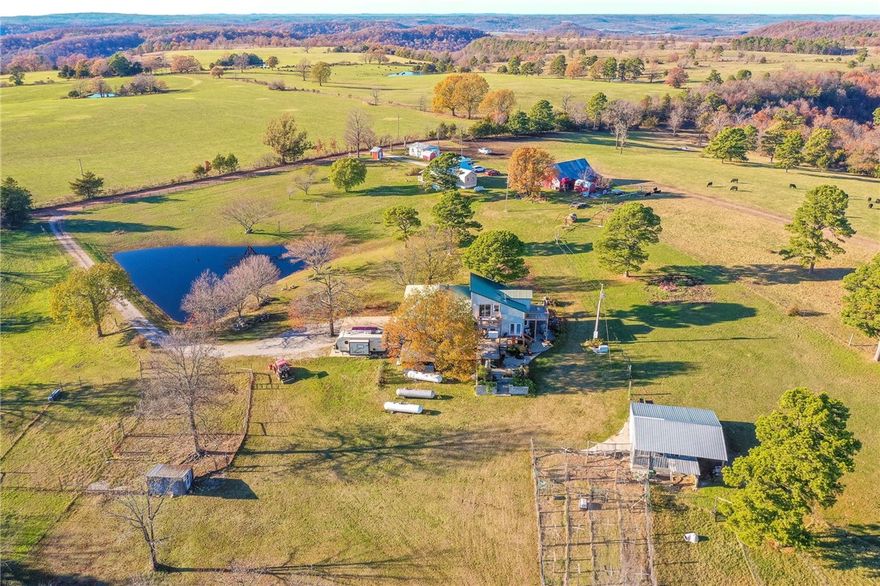 Small Ozark farm joining Nature Conservancy in Northwest Arkansas. Live Off Grid if needed. 8 acres m/l with a Primary Residence: 3,400 (m/l) sf, 3-4 BR/3 BA; open-concept, wood-burning stove. Walk-out, reinforced basement; safe room, 2nd laundry, 3 BR, storage, radiant wood stove heat. Outdoor heated swim spa, wrap-around decks, 2 Generators, big Ozark Mountain views. Additional Dwellings: 3 BR/1 BA Guesthouse; 1 BR/1 BA Cabin/Office Infrastructure: Metal Barn, Chicken Coop; electric, water, storage, Barn and solar power mounts and panels for off-grid potential. Minutes from Berryville, Kings River, White River and Beaver Lake. Joining the Nature Conservancy Kings River Preserve with biking and hiking trails throughout the Kings River corridor. BONUS FEATURE FOR AVIATION ENTHUSIASTS: FLY-IN to your Ozark Mountain dream; estate located directly across from Trigger Gap Airstrip. Check out https://www.flyoz.com/trigger-gap/ for more info. MORE LAND AVAILABLE UP TO 65 ac AC TOTAL w/ cave, springs,Bluffs