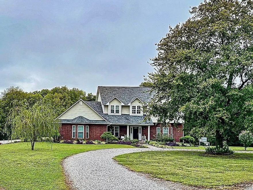 Discover 358 Northfork Dr, Berryville, AR 72616—a 2-story, 3-bedroom, 2.5-bathroom home on an expansive private 4.82-acre lot. With 2,409 sq. ft. of living space and a 734-sq.-ft. finished garage.
The main level offers an open layout with a gas fireplace, a dedicated office, and a kitchen with modern appliances. A 200-sq.-ft. covered back porch overlooks the lot. The home features hardwood, tile, carpet, and vinyl flooring. Upstairs, the primary suite includes a large window for sunrises and an en-suite bathroom with a jacuzzi tub. Two additional bedrooms and a half-bath on the main level add convenience. A 2019 roof and central heat/air ensure low maintenance. 10x16 metal storage building and an 11x16 wooden outbuilding with electric. A storm shelter in the garage and a well (with city water hookup) add practicality.