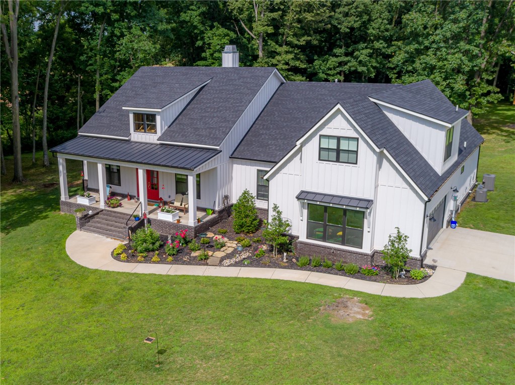 Country living on 5 acres that is still close to the city, airport and Walmart Corporate Offices. This modern farmhouse with thoughtful finishes throughout will take your breath away! Gorgeous barrel ceilings welcome you into this one of a kind space. Main level includes Chef’s kitchen with Fisher & Paykel appliances away from bedrooms to minimize noise. Master suite is complete with workout room/office and oversize soaker tub/walk in shower with on-demand hot water throughout. Super large laundry room and master closet connect to master bedroom for convenience. Upstairs boasts en suite bedroom/media room for visitors to have privacy. Other features include spray foam attic insulation to lower utility bills, extra-large and private back vaulted ceiling patio that can be easily tiled and screened in if needed, wired for security and sound system inside and out. Top of the line storage garage in back of property to help minimize garage clutter. Still have plenty of room to put in pool or shop building.