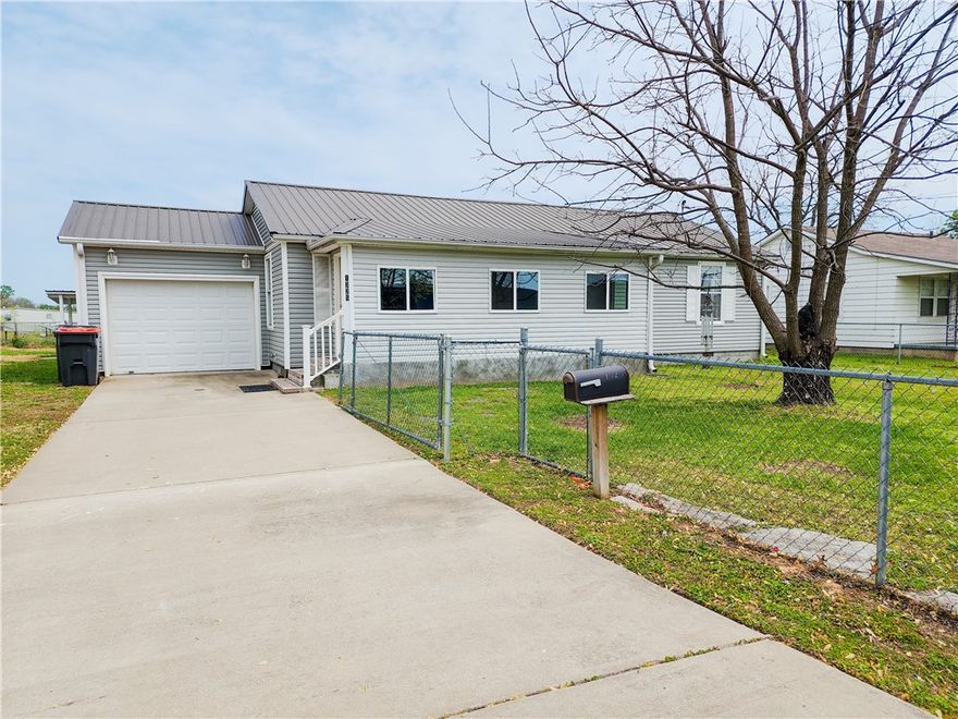 Full of charm and character, this 1,796 sq ft home near downtown Springdale is anything but cookie cutter! Inside, you'll find 3 bedrooms, 2 bath, a large laundry room and two versatile bonus rooms—ideal for storage, hobbies, or creative projects. The front yard is fully fenced, while the backyard features a cozy, covered seating area perfect for relaxing or entertaining. As a bonus, the business behind the home has a beautiful pond visible from the property, offering a peaceful, picturesque view. Just minutes from downtown Springdale, this home blends unique style with everyday convenience.