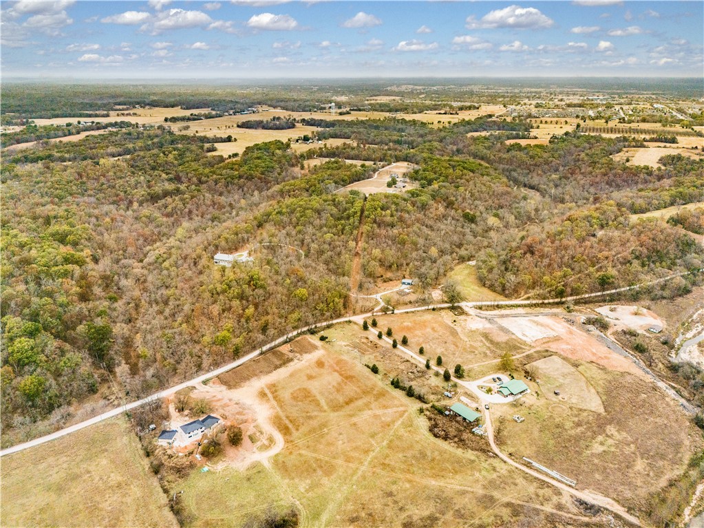 Set amid the rolling hills of North Bentonville, this picturesque 13.91± acre property blends serene woodlands with open, gently cleared pastureāideal for equestrian use or private estate living. Multiple potential build sites offer flexibility to create your dream home, framed by nature and privacy. A paddock with shelter is already in place for horses, and a natural stream winds through the land, enhancing the peaceful atmosphere. Home to native wildlife and mature hardwoods, this acreage is both a sanctuary and an opportunityājust 15 minutes from downtown Bentonville and a private airport.